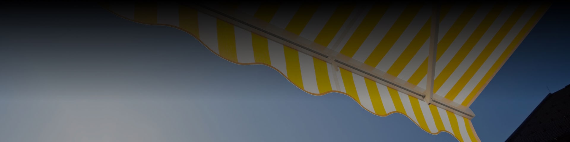 Under view of yellow and white striped patio awning