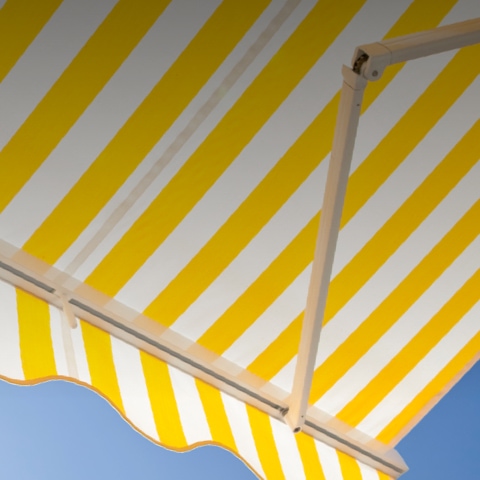 Under view of yellow and white striped patio awning